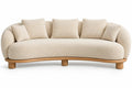 Sofá curvo tapizado de contorno redondeado, beige y marrón
